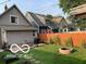 Landscaped backyard featuring a fire pit and wood fence for privacy at 2001 Hoyt Ave, Indianapolis, IN 46203