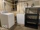 Unfinished basement laundry area with washer, dryer and storage shelving at 2001 Hoyt Ave, Indianapolis, IN 46203