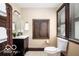 Well-lit bathroom with a dark wood cabinet sink and a large window for natural light at 2001 Hoyt Ave, Indianapolis, IN 46203