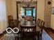 Elegant dining room with a long table and an open view to the living room at 2001 Hoyt Ave, Indianapolis, IN 46203