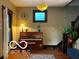 Inviting entryway showcasing a piano, warm lighting, and hardwood floors at 2001 Hoyt Ave, Indianapolis, IN 46203