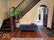 Spacious hallway with wooden staircase, bench and beautiful hardwood floors at 2001 Hoyt Ave, Indianapolis, IN 46203