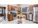 Well-lit kitchen with wooden cabinetry, stainless steel appliances, and an island providing extra workspace at 2001 Hoyt Ave, Indianapolis, IN 46203