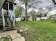 Lush backyard featuring two storage buildings, mature trees and a lush lawn at 210 Prairie Pkwy, Brownsburg, IN 46112