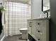 Stylish bathroom with a marble vanity, matte black fixtures, and a shower with a modern curtain at 210 Prairie Pkwy, Brownsburg, IN 46112
