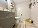 Powder room featuring a modern vanity, decorative shelves, and a stylish color scheme at 210 Prairie Pkwy, Brownsburg, IN 46112