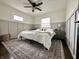 Bright bedroom featuring wainscotting, a ceiling fan, and a large window with a serene view at 210 Prairie Pkwy, Brownsburg, IN 46112