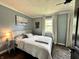 Charming bedroom with fresh blue paint, a ceiling fan, and large windows letting in ample natural light at 210 Prairie Pkwy, Brownsburg, IN 46112