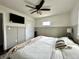 Bright bedroom featuring wainscotting, a ceiling fan, and a TV at 210 Prairie Pkwy, Brownsburg, IN 46112