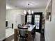 Bright dining area featuring a rustic wooden table, chic black chairs, and modern chandelier at 210 Prairie Pkwy, Brownsburg, IN 46112