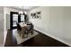 Bright dining room features a wooden table, modern chandelier, and a door to the outside at 210 Prairie Pkwy, Brownsburg, IN 46112