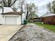 Home exterior showcasing a long driveway leading to the attached garage and backyard with storage at 210 Prairie Pkwy, Brownsburg, IN 46112