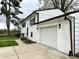White painted brick two-story house with an attached garage and manicured lawn at 210 Prairie Pkwy, Brownsburg, IN 46112
