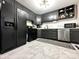 Modern kitchen with sleek black cabinets, stainless steel appliances, and stylish countertops at 210 Prairie Pkwy, Brownsburg, IN 46112