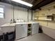 Basement laundry area featuring a utility sink, washer, dryer and some storage shelving at 210 Prairie Pkwy, Brownsburg, IN 46112