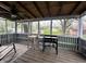 Relaxing screened porch featuring wood flooring, ceiling fan, lights, and a Blackstone cooking station at 210 Prairie Pkwy, Brownsburg, IN 46112