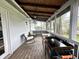Inviting screened porch with rocking chairs, wood flooring, fan, lights, and a view to the backyard at 210 Prairie Pkwy, Brownsburg, IN 46112