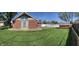 A lush backyard with a shed, patio, and a brick house at 2141 N Cole St, Indianapolis, IN 46224
