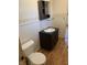 Bathroom with a toilet, sink, and storage, with wood look linoleum floors at 2141 N Cole St, Indianapolis, IN 46224