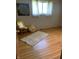 Neutral bedroom with hardwood floors, a sunny window with sheer curtains and an area rug at 2141 N Cole St, Indianapolis, IN 46224