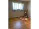 Bright bedroom with hardwood floors, a sunny window with sheer curtains and modern decorations at 2141 N Cole St, Indianapolis, IN 46224