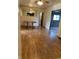 View of the dining room featuring hardwood floors, a ceiling fan, a dining table, and access to other rooms in the home at 2141 N Cole St, Indianapolis, IN 46224
