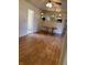 View of the dining room featuring hardwood floors, a ceiling fan, a dining table, and access to other rooms in the home at 2141 N Cole St, Indianapolis, IN 46224