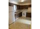 A kitchen with brown wood cabinets, laminate countertops, and white appliances at 2141 N Cole St, Indianapolis, IN 46224