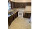Kitchen with wooden cabinets, an oven, and a sink at 2141 N Cole St, Indianapolis, IN 46224