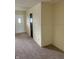 View of the living room with carpet flooring and a white door at 2141 N Cole St, Indianapolis, IN 46224