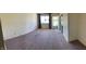 Spacious living room with carpet and ample natural light through a window at 2141 N Cole St, Indianapolis, IN 46224
