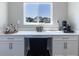 Built-in bar area with counter space, cabinetry, and natural light from the window at 2168 Hengist Dr, Westfield, IN 46074