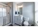Well-lit bathroom with a modern vanity, tiled shower, and ample natural light from the window at 2168 Hengist Dr, Westfield, IN 46074