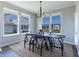 Bright dining room with large windows, modern lighting, and seating for six at 2168 Hengist Dr, Westfield, IN 46074