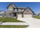 Beautiful two-story brick home with a three-car garage and well-manicured lawn at 2168 Hengist Dr, Westfield, IN 46074
