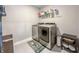 Modern laundry room features a front-load washer and dryer set with ample shelving for storage at 2168 Hengist Dr, Westfield, IN 46074