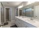 Main bathroom with dual sinks, a quartz countertop, a large mirror, and a walk-in shower at 2168 Hengist Dr, Westfield, IN 46074
