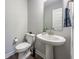 Stylish powder room featuring a pedestal sink, modern fixtures, and neutral color palette at 2168 Hengist Dr, Westfield, IN 46074