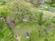 An aerial view of a home with a large yard, mature trees, and a storage shed, showcasing its outdoor space at 225 Vali Ct, Carmel, IN 46280