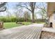 Spacious backyard featuring mature trees, a fire pit, and a wooden deck at 225 Vali Ct, Carmel, IN 46280