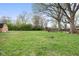 Expansive backyard featuring mature trees, a swing set, and plenty of green space at 225 Vali Ct, Carmel, IN 46280