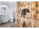 Bathroom featuring charming bear-themed shower curtain, a toilet, vanity, and soft gray walls at 225 Vali Ct, Carmel, IN 46280