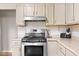 Kitchen details showcasing the gas range and upper cabinetry at 225 Vali Ct, Carmel, IN 46280