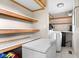 Laundry room featuring shelving, a deep freezer, and a modern washer and dryer at 225 Vali Ct, Carmel, IN 46280