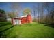 Bright red barn featuring a single garage door and situated on a well-manicured green lawn at 2394 W 600 S, New Palestine, IN 46163