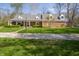 Charming brick home featuring a spacious front yard, covered porch, and classic dormer windows at 2394 W 600 S, New Palestine, IN 46163