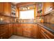 Updated kitchen with granite countertops, custom cabinetry, and a window offering lots of natural light at 2394 W 600 S, New Palestine, IN 46163