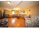 Spacious living room with hardwood floors, a large sectional sofa, and neutral wall paint at 2394 W 600 S, New Palestine, IN 46163