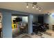 The basement entertainment area offers seating, a TV, and a classic arcade game for leisure and relaxation at 263 Clark Ave, Beech Grove, IN 46107