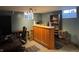 The basement boasts a wooden bar area with stools, perfect for entertaining in this versatile living space at 263 Clark Ave, Beech Grove, IN 46107